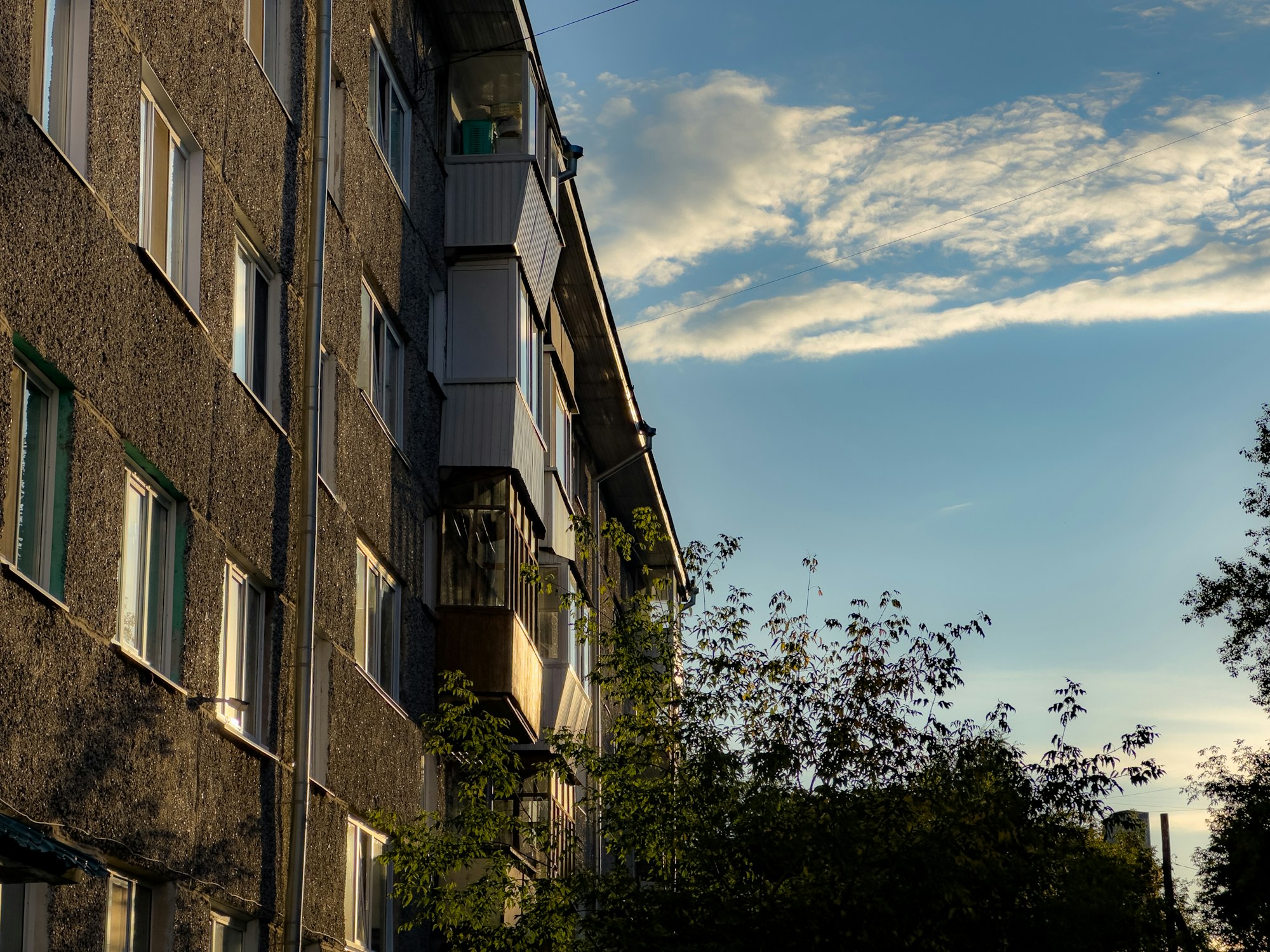 Exterior of a residential apartment building against a clear sky
