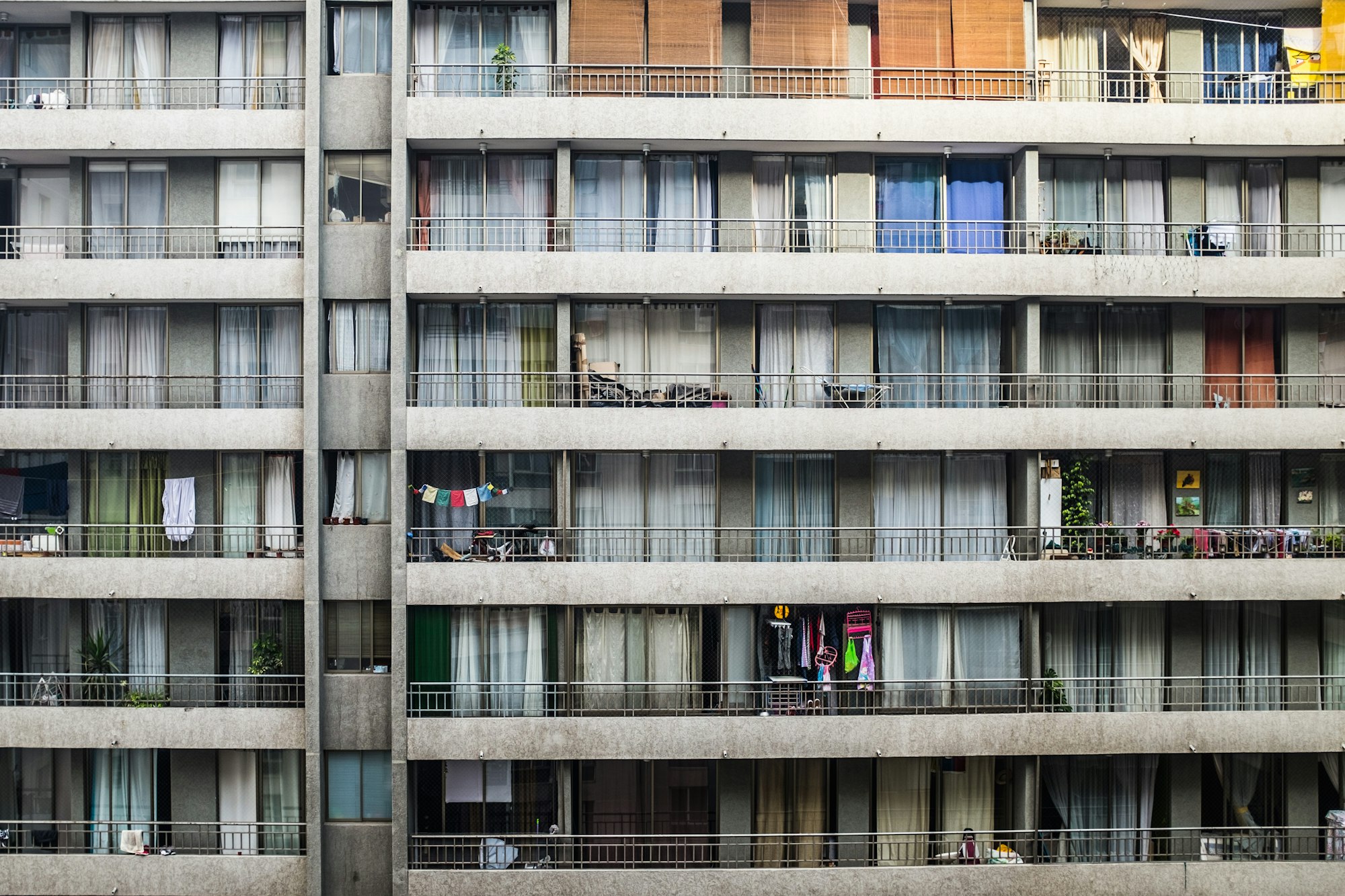 Facade of a residential apartment building with rows of balconies